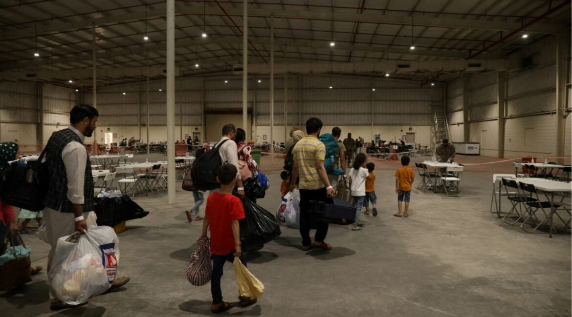 Special Immigrants from Afghanistan walk through the in-processing building after their evacuation at Camp As Sayliyah, Qatar, August 20, 2021. (Reuters File)