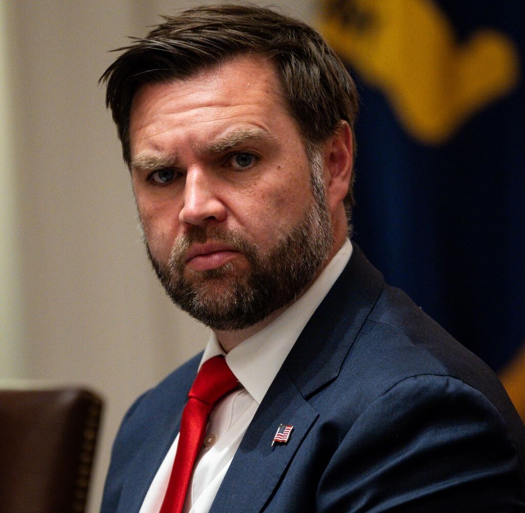 Image of Vice President JD Vance in a blue suit, white shirt, and red tie