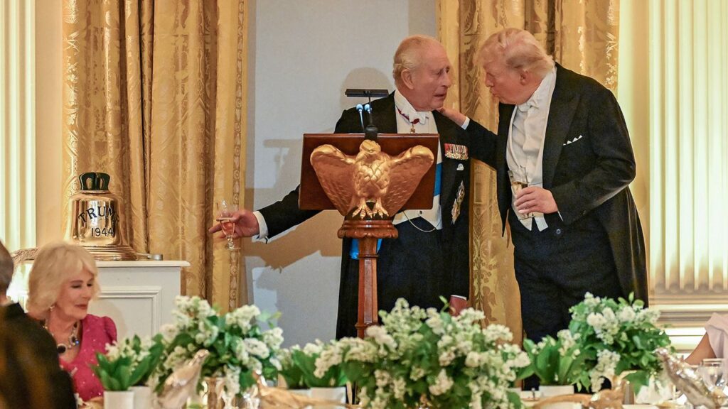 King Charles III of the United Kingdom, left, and President Donald Trump greet each other during a state dinner in the East Room of the White House in Washington, on Tuesday, April 28, 2026. King Charles III presented President Trump with a gift on Tuesday during his state visit to the United States: the original bell from the H.M.S. Trump, a British submarine that served during World War II. (Kenny Holston/The New York Times)