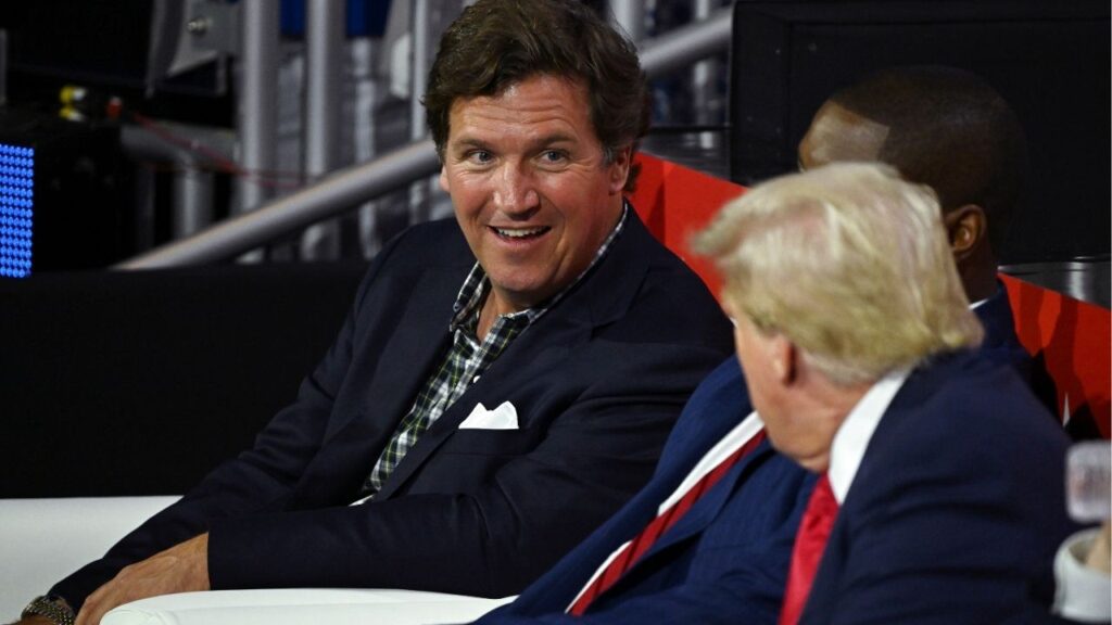 Tucker Carlson speaks with former President Donald Trump on the first day of the Republican National Convention at the Fiserv Forum in Milwaukee, July 15, 2024. Carlson, who was often at Trump’s side during the 2024 presidential campaign, is now expressing remorse for that support, saying he will long be “tormented” by his role helping Trump return to the White House. (Kenny Holston/The New York Times)