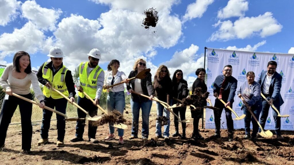 Image of residents and officials in East Orosi, California, holding ceremonial shovels for a groundbreaking on a water plant