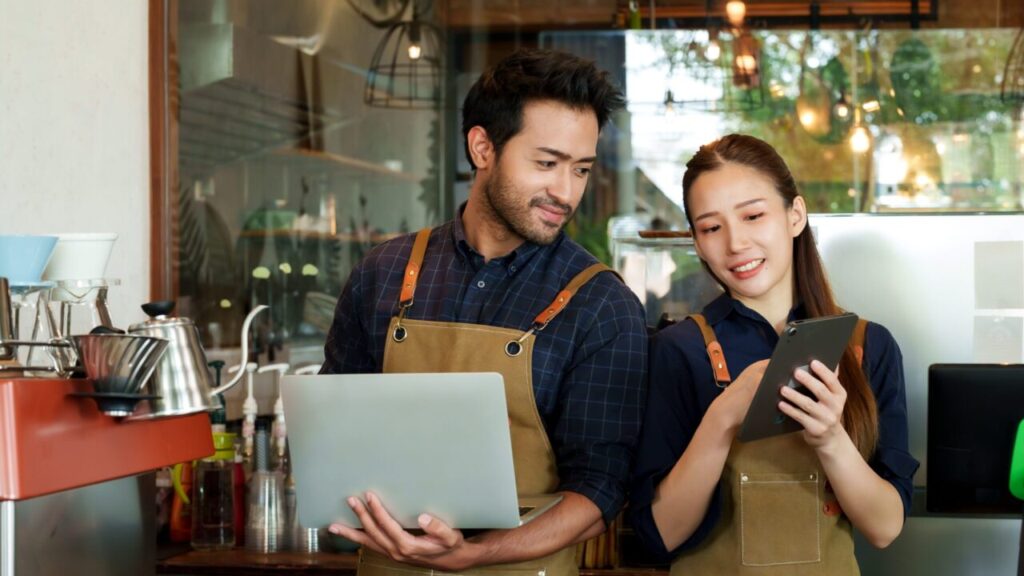 Image of a Hispanic man and Asian woman who are in business together running a clothing boutique and coffee shop