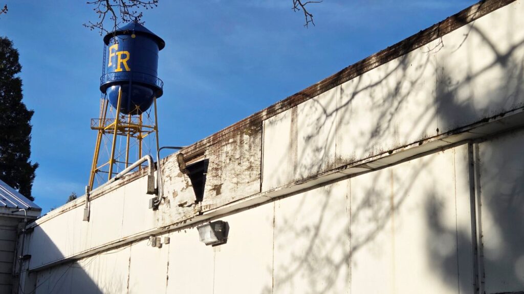 Image of a decaying white wall at a northern California high school