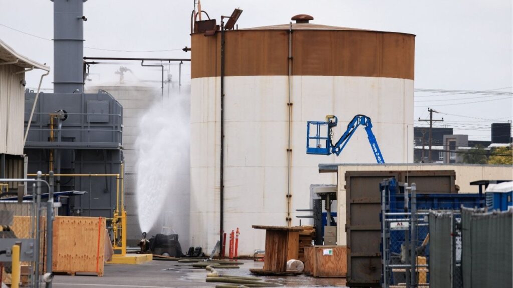 A drone view shows water being sprayed during a chemical incident involving a leaking tank of methyl methacrylate, a flammable liquid used in the aerospace industry, forcing an evacuation in the surrounding area, in Garden Grove, California, U.S., May 23, 2026. REUTERS/David Swanson