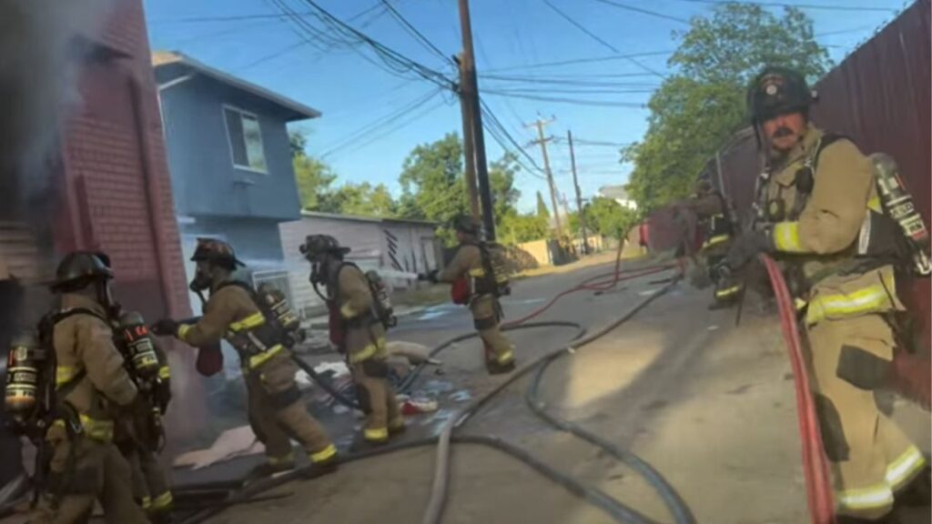 A firefighter suffered minor injuries Tuesday night when part of a vacant commercial building collapsed during a large fire in central Fresno that destroyed the structure but spared nearby buildings. (Fresno FD)