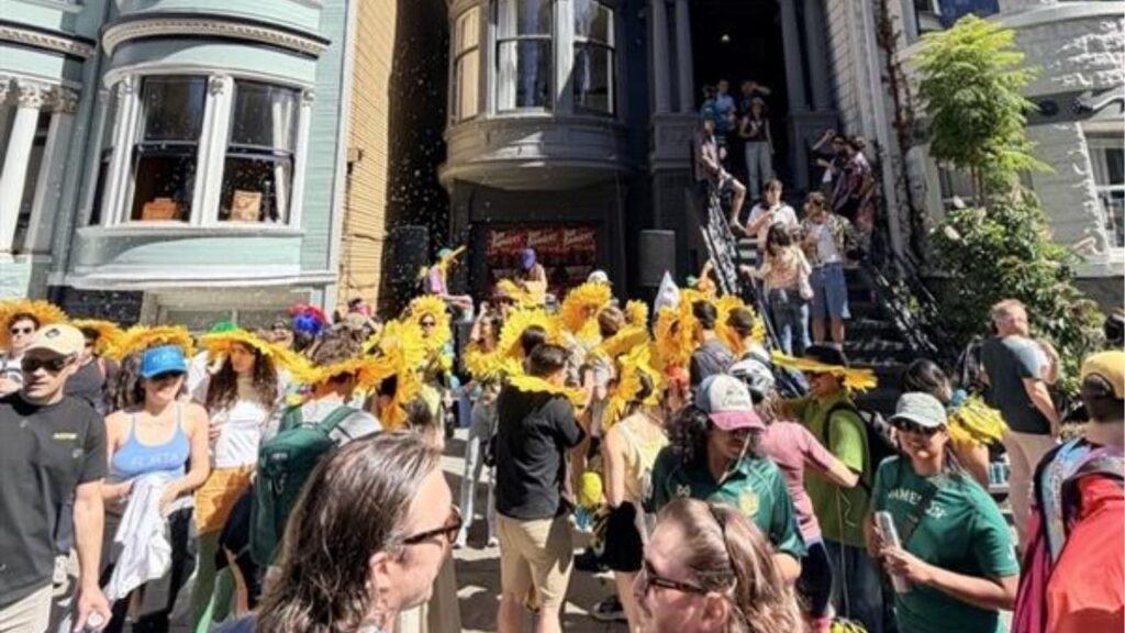 A group of sunflowers danced to a DJ on the sidewalk by Bay to Breakers on May 17. 2026. (Anthony W. Haddad)