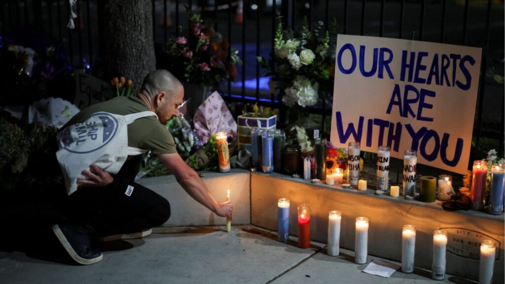 A man places a candle on the ground as he pays his respects in front of the Islamic Center of San Diego after the vigil in a park, the day after a fatal shooting incident, in San Diego, California, U.S., May 19, 2026. (Reuters/Daniel Cole)