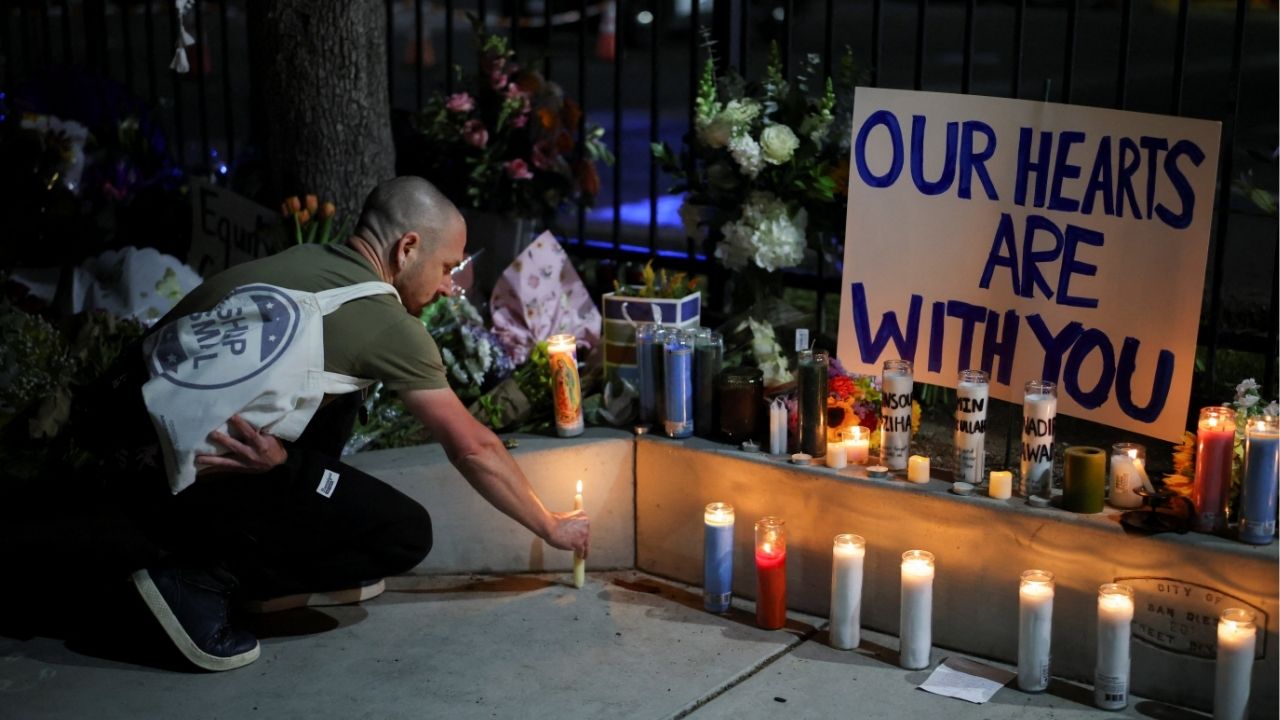 A man places a candle on the ground as he pays his respects in front of the Islamic Center of San Diego after the vigil in a park, the day after a fatal shooting incident, in San Diego, California, U.S., May 19, 2026. (Reuters/Daniel Cole)