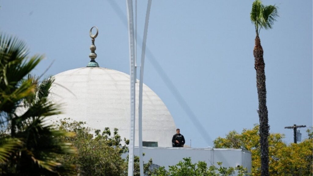 A police officer stands guard as emergency workers respond at the scene of a reported active shooter situation at the Islamic Center in San Diego, California, U.S., May 18, 2026. REUTERS/Mike Blake