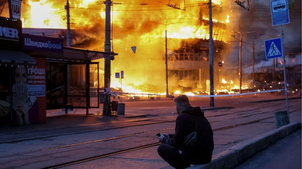 A resident sits at a site of a Russian missile and drone strike, amid Russia's attack on Ukraine, in Kyiv, Ukraine May 24, 2026. REUTERS/Stringer