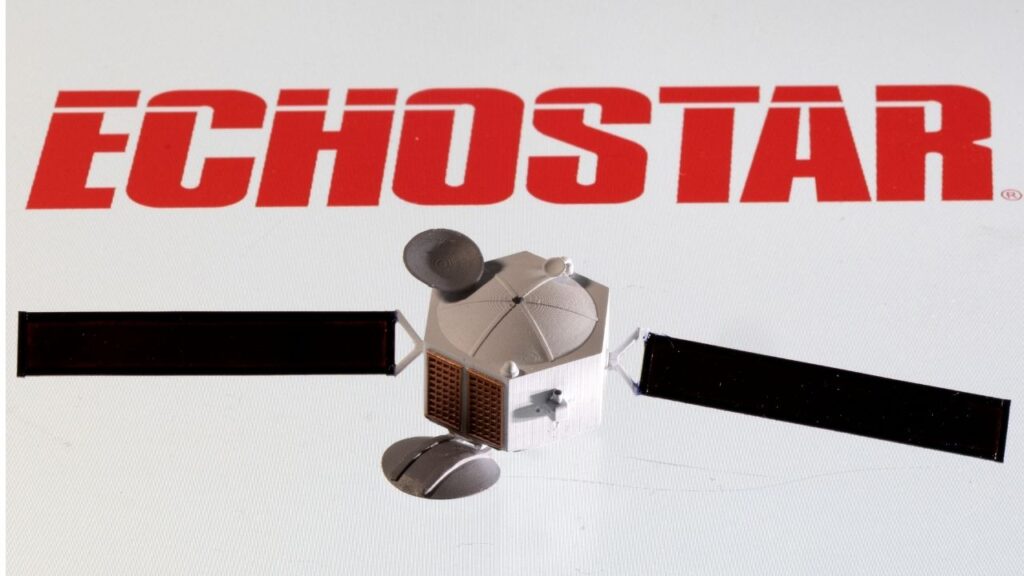 A satellite model is placed on EchoStar Satellite Services logo in this picture illustration taken April 4, 2022. (Reuters/Dado Ruvic/Illustration)