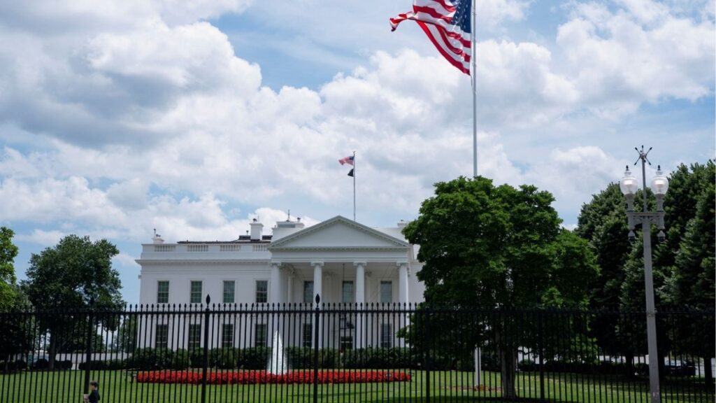 A visitor walks past the White House and a new flag pole installed on the North Lawn in Washington, D.C., U.S., June 19, 2025.(Reuters/Nathan Howard)