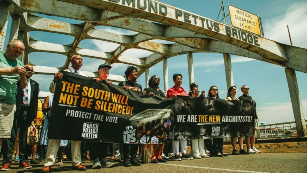 A voting rights march crosses the Edmund Pettus Bridge in Selma, Ala., on May 16, 2026. A panel of federal judges on May 26 rejected Alabama’s effort to use a new voting map for the November midterm elections, saying that the districts discriminated against Black people and could not be used so shortly before a vote; the state is likely to appeal to the Supreme Court. (Wes Frazer/The New York Times)
