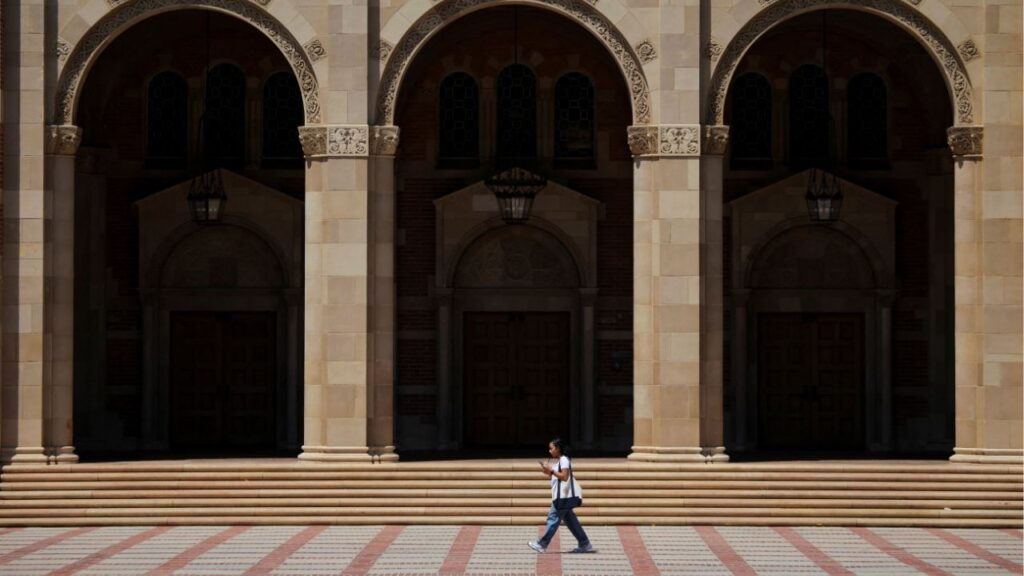 A woman walks by Royce Hall at the University of California Los Angeles (UCLA) in Los Angeles, California, U.S., August 11, 2025. (Reuters/Daniel Cole)