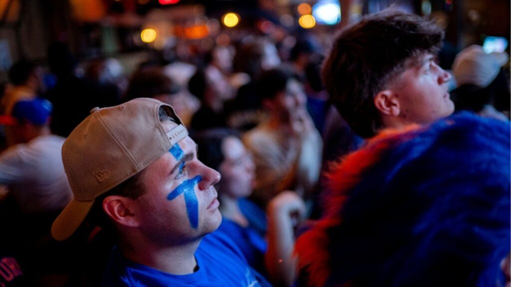 At a bar near Madison Square Garden in New York, Knicks fans watch as their team sweeps the Cleveland Cavaliers in the Eastern Conference Finals to advance to the NBA Finals for the first time since 1999 on Monday night, May 25, 2026. Thousands of fans blocked traffic outside Madison Square Garden, even though the game was in Ohio and the outdoor watch parties at the Garden had been suspended because of rowdy fans. (Vincent Alban/The New York Times)