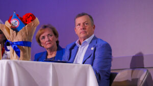 Clovis City Councilmember Lynne Ashbeck, left, watches alongside Councilmember Matthew Basgall as Clovis Mayor Vong Mouanoutoua delivers remarks during the 2026 Clovis Mayor’s Annual Breakfast in Clovis, California. (GV Wire/Eric Martinez)