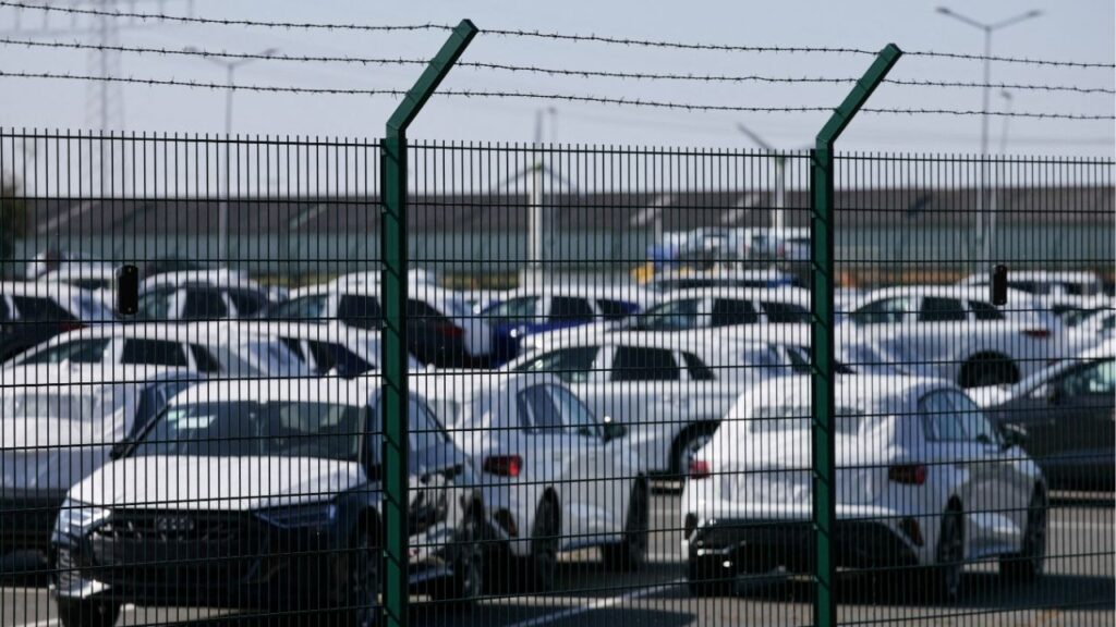 Cars of the Volkswagen Group intended for export to the United States are seen behind a fence at the seaport of Emden near the estuary, where the River Ems flows into the North Sea, in Emden, Germany, April 2, 2025. (Reuters/Wolfgang Rattay)