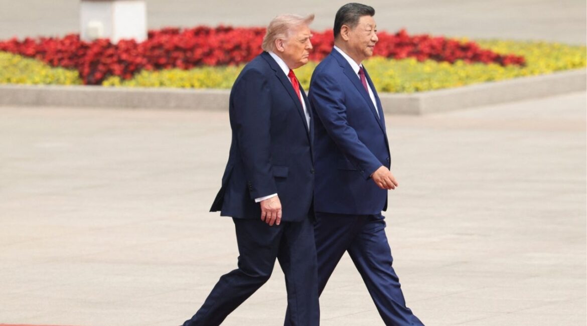 Chinese President Xi Jinping walks with U.S. President Donald Trump during a welcome ceremony at the Great Hall of the People, in Beijing, China, May 14, 2026. REUTERS/Maxim Shemetov/Pool