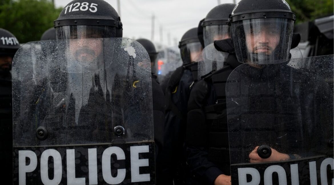 City of Newark police officers in riot gear monitor the anti-ICE demonstrations and counterprotests outside Delaney Hall, a federal detention facility in Newark, N.J. on Saturday, May 30, 2026. Clashes between protesters and armed federal agents here have flared off and on since the Memorial Day weekend; on Friday, federal officials left the area outside the detention center so that the state police could assume control. (Vincent Alban/The New York Times)