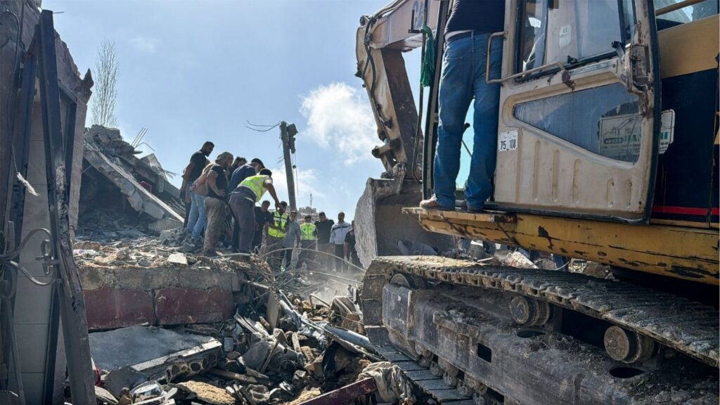 Emergency responders assisted by other people and heavy machinery inspect the site of an Israeli strike in Saksakiyeh, Lebanon, May 9, 2026. Picture taken with a mobile phone. REUTERS/Stringer