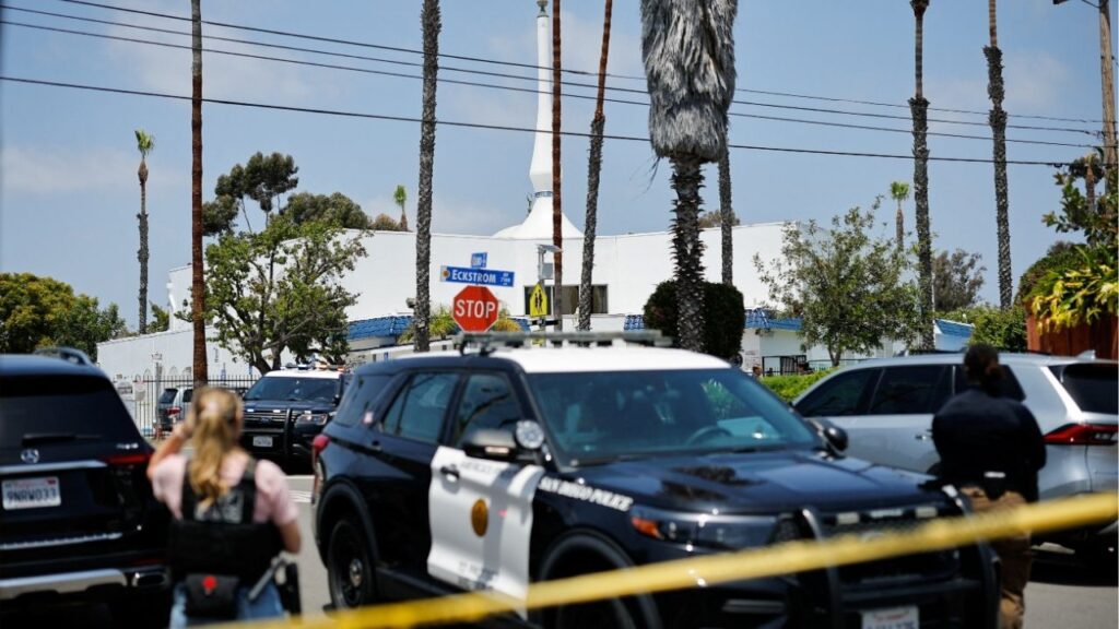 Emergency workers respond at the scene of a reported active shooter situation at the Islamic Center, with yellow tape to cordon the area in the foreground, in San Diego, California, U.S., May 18, 2026. REUTERS/Mike Blake