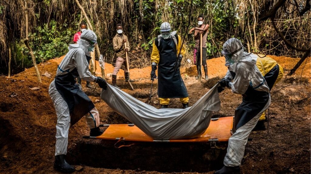 FILE — A team in Gbarnga, Liberia, buries a 37-year-old mother of three who died before she reached a center that could treat her during the Ebola outbreak of 2014, Oct. 5, 2014. An outbreak of the deadly Ebola virus in the Democratic Republic of Congo and Uganda has prompted the World Health Organization to declare a global health emergency. (Daniel Berehulak/The New York Times)