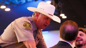 Fresno County Sheriff John Zanoni speaks with Fresno County Supervisor Garry Bredefeld and Clovis City Council candidate Mason Magsig during the 2026 Clovis Mayor’s Annual Breakfast in Clovis, California. (GV Wire/Eric Martinez)