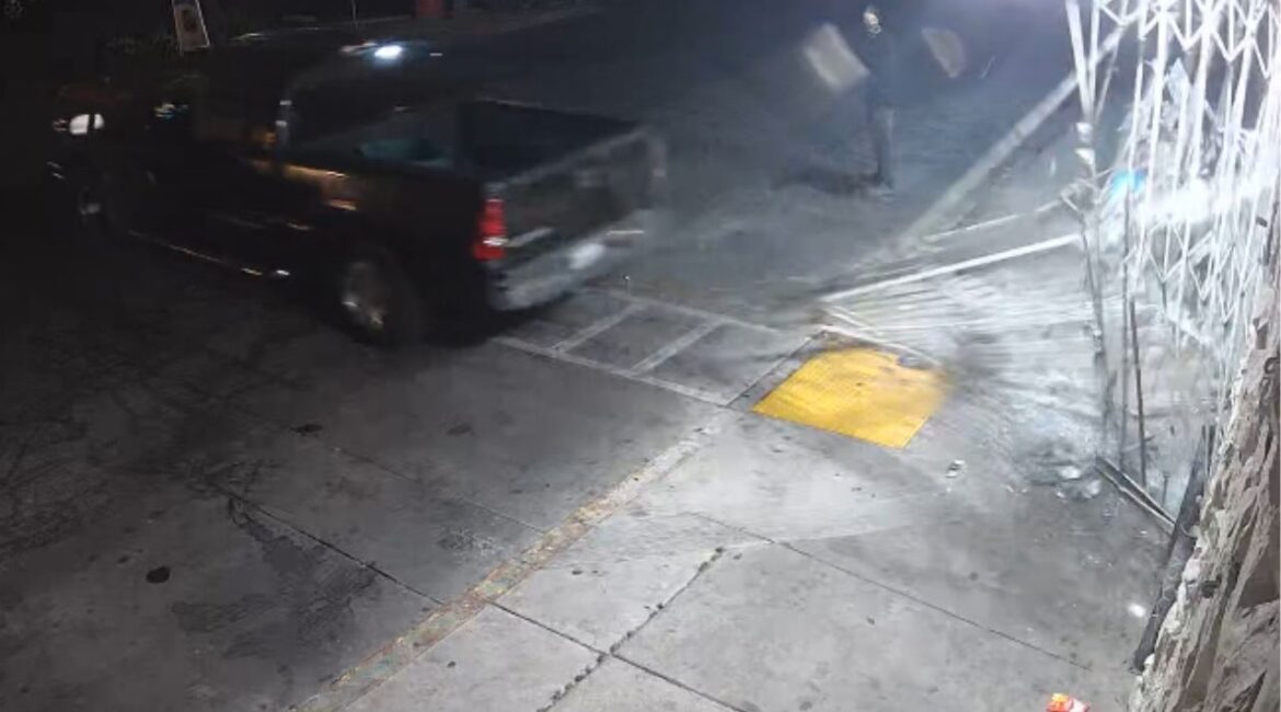 Fresno police are investigating an early morning burglary at Meta Liquor where suspects used a homemade tool to tear down a security gate and steal merchandise. (Screengrab)