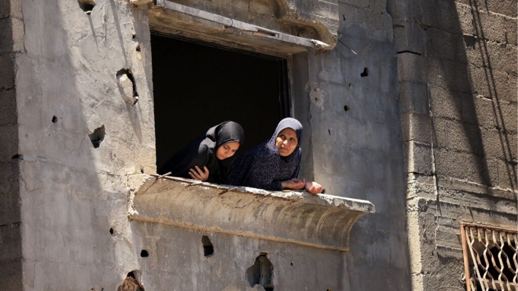 Palestinian women look from a damaged house at the site of an Israeli strike on a house that was pre-warned by the Israeli military to evacuate, before the strike was carried out late on Thursday at Shati (Beach) refugee camp, in Gaza City, May 29, 2026. (Reuters/Dawoud Abu Alkas)