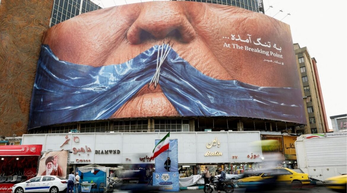 People drive past an anti-U.S. billboard depicting U.S. President Donald Trump and the Strait of Hormuz, in Tehran, Iran, May 17, 2026. (Reuters File)