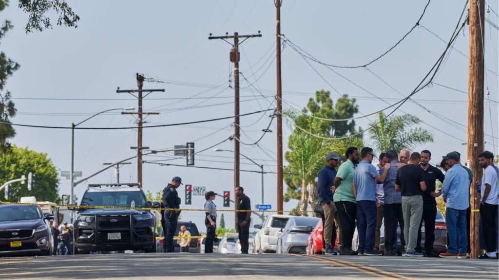 People embrace outside the Islamic Center of San Diego after at least three people were killed in an attack there on Monday, May 18, 2026. Three men were killed in the attack, including a security guard who officials credited with preventing a more deadly massacre at the mosque. (John Francis Peters/The New York Times)