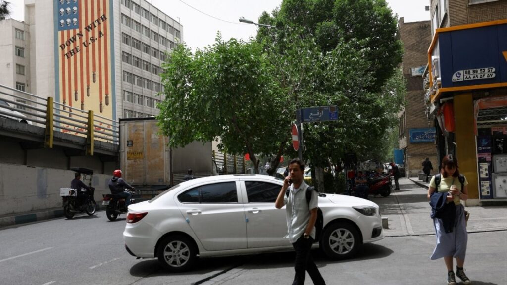 People walk near an anti-U.S. mural on a building in Tehran, Iran, May 19, 2026. Majid Asgaripour/WANA (West Asia News Agency) via REUTERS