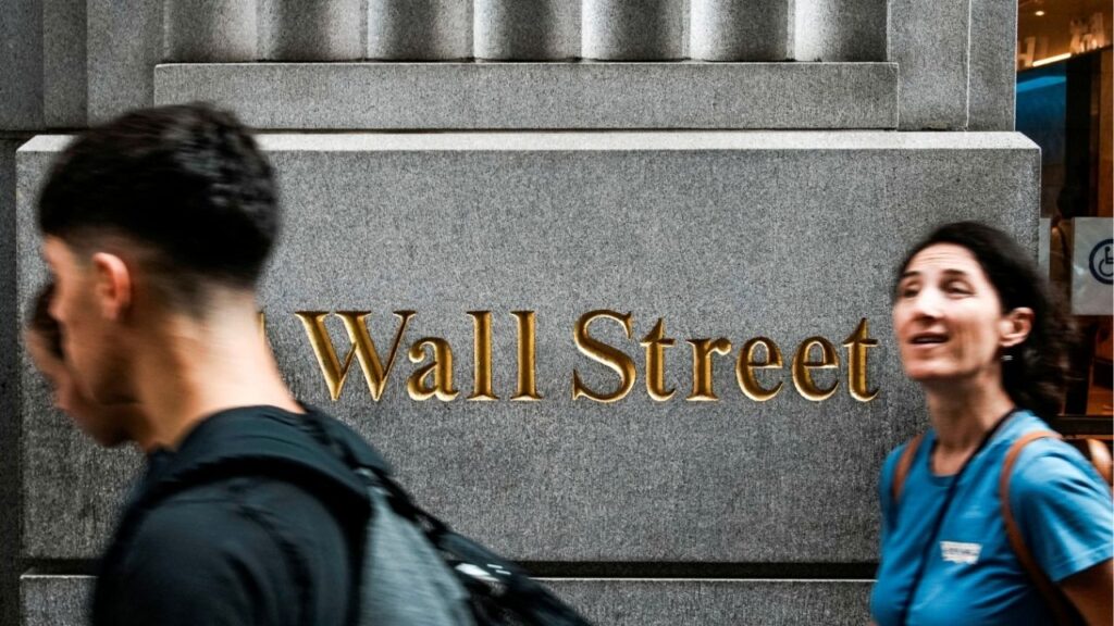 People walk near the New York Stock Exchange (NYSE) in New York City, New York, U.S., August 7, 2025. REUTERS/Eduardo Munoz
