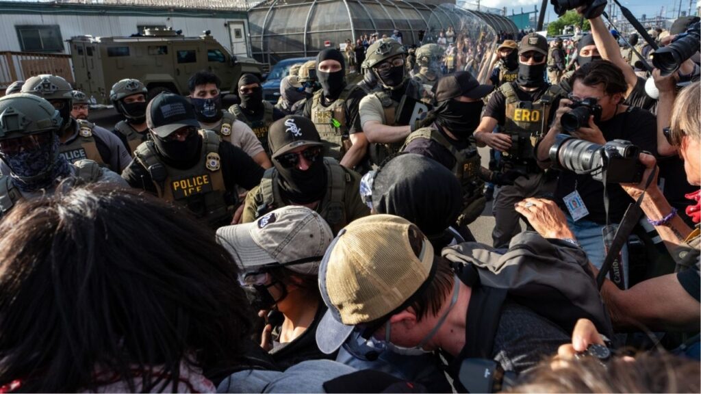 Protesters scuffle with masked immigration agents during a demonstration outside Delaney Hall, an immigration detention center in Newark, N.J., on Thursday evening, May 28, 2026. For nearly a week, relatives of migrants at Delaney Hall have said that some detainees have been on a hunger strike at the facility. Federal officials have denied that a hunger strike is taking place. (Todd Heisler/The New York Times)