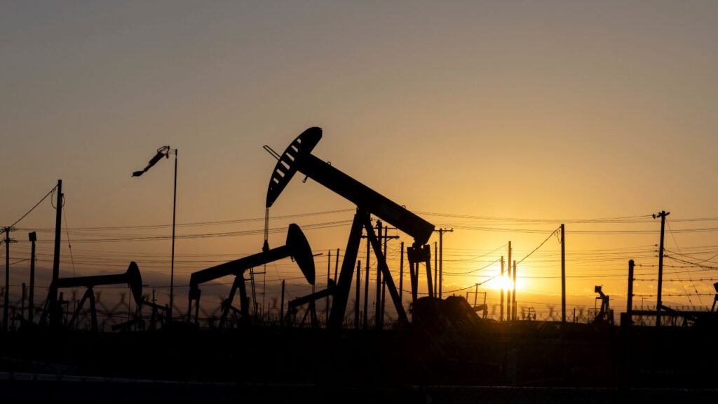 Image of oil pumps near Bakersfield, California, as the sun sets on the horizon