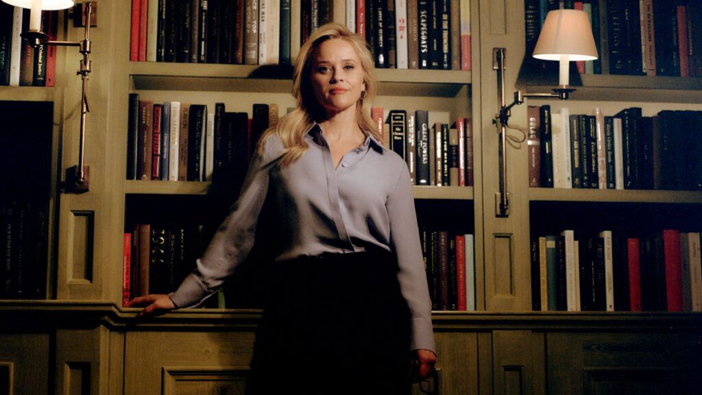 Image of Reese Witherspoon standing in a home library facing the camera