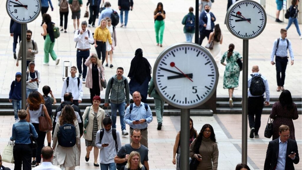 Workers walk through the Canary Wharf financial district, in London, Britain, August 3, 2023. (Reuters File)