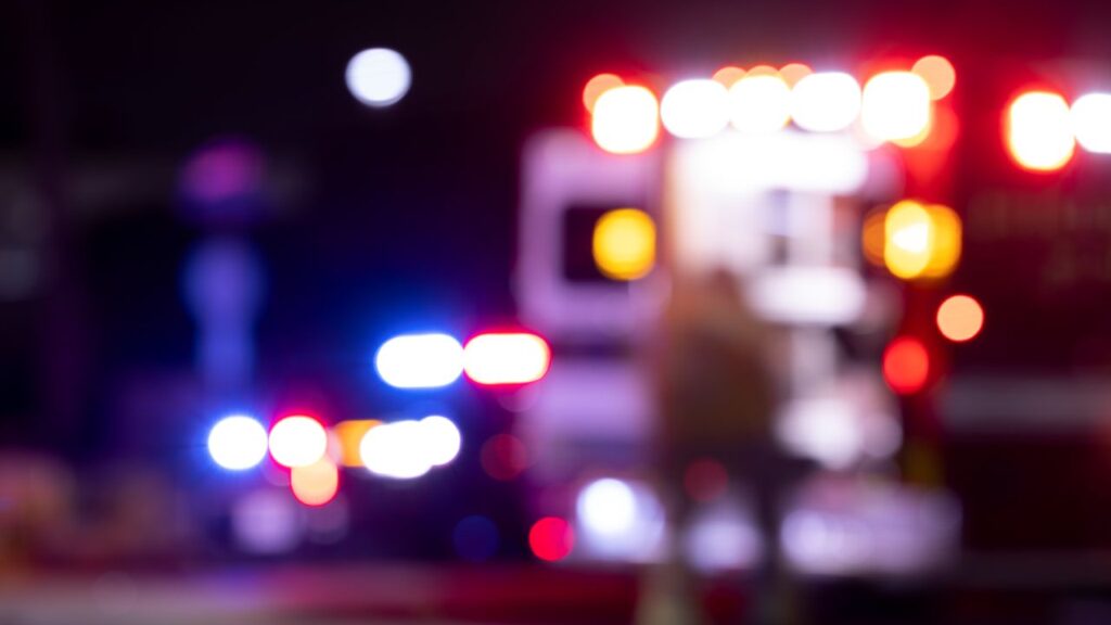 Blurred night image of first responders at the scene of an emergency