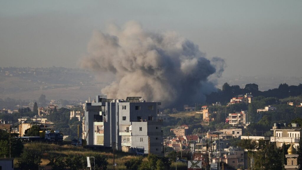 Image of light gray ash and smoke following an Israeli missile strike in a Lebanese city