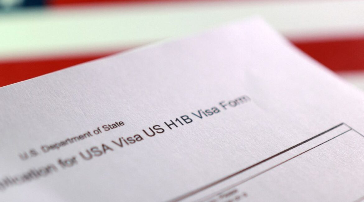 A U.S. flag and a U.S. H-1B Visa application form are seen in this illustration taken, September 22, 2025. (Reuters/Dado Ruvic/Illustration)