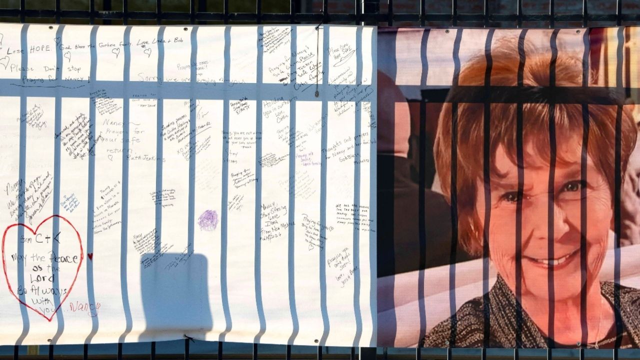 A banner with a growing collection of well-wishes from supporters reads "bring her home" (not pictured) and shows a photo of Nancy Guthrie, the 84-year-old mother of U.S. journalist and television host Savannah Guthrie, who disappeared from her home nearly two weeks ago, outside of the KVOA newsroom in Tucson, Arizona, U.S., February 14, 2026. REUTERS/Rebecca Noble