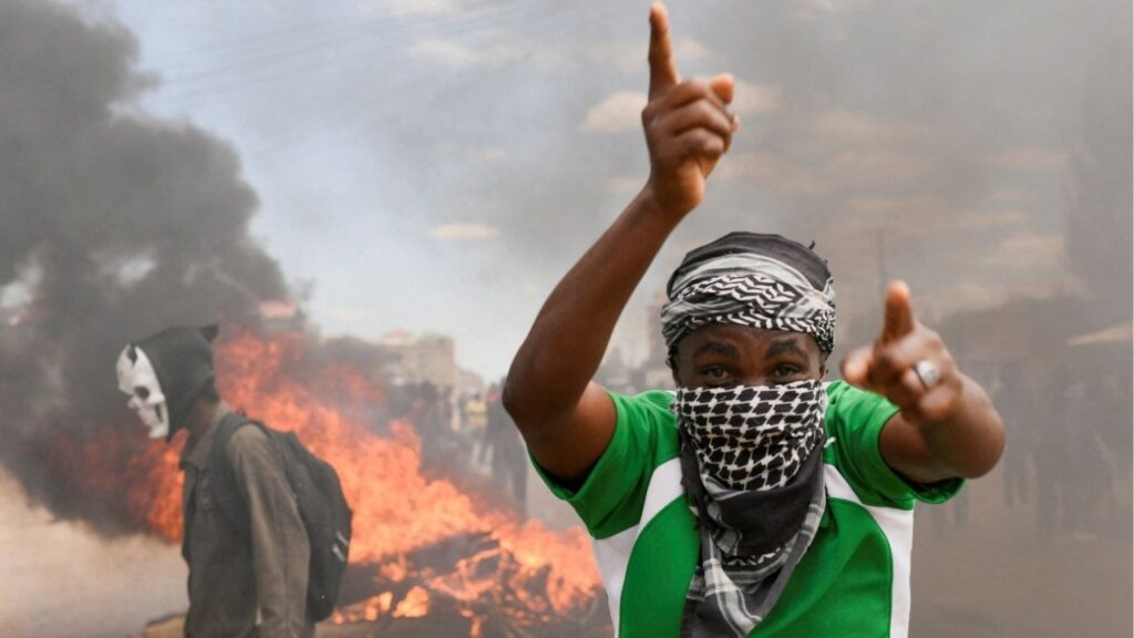 A demonstrator gestures as they erect a barricade during a protest against a U.S.-backed Ebola quarantine plan on the establishment of a 50-bed facility at a Kenyan air force base that was intended to host Americans exposed to Ebola, in Nanyuki town, in Laikipia County, Kenya June 1, 2026. (Reuters/John Muchucha)