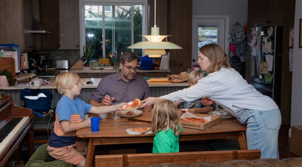 A family of five in the Astoria neighborhood of Queens, on Oct. 3, 2025. In most families in the United States, parents work full time — and 60% of those who do say they spend too little time with their children, according to a new survey. (Natalie Keyssar/The New York Times)