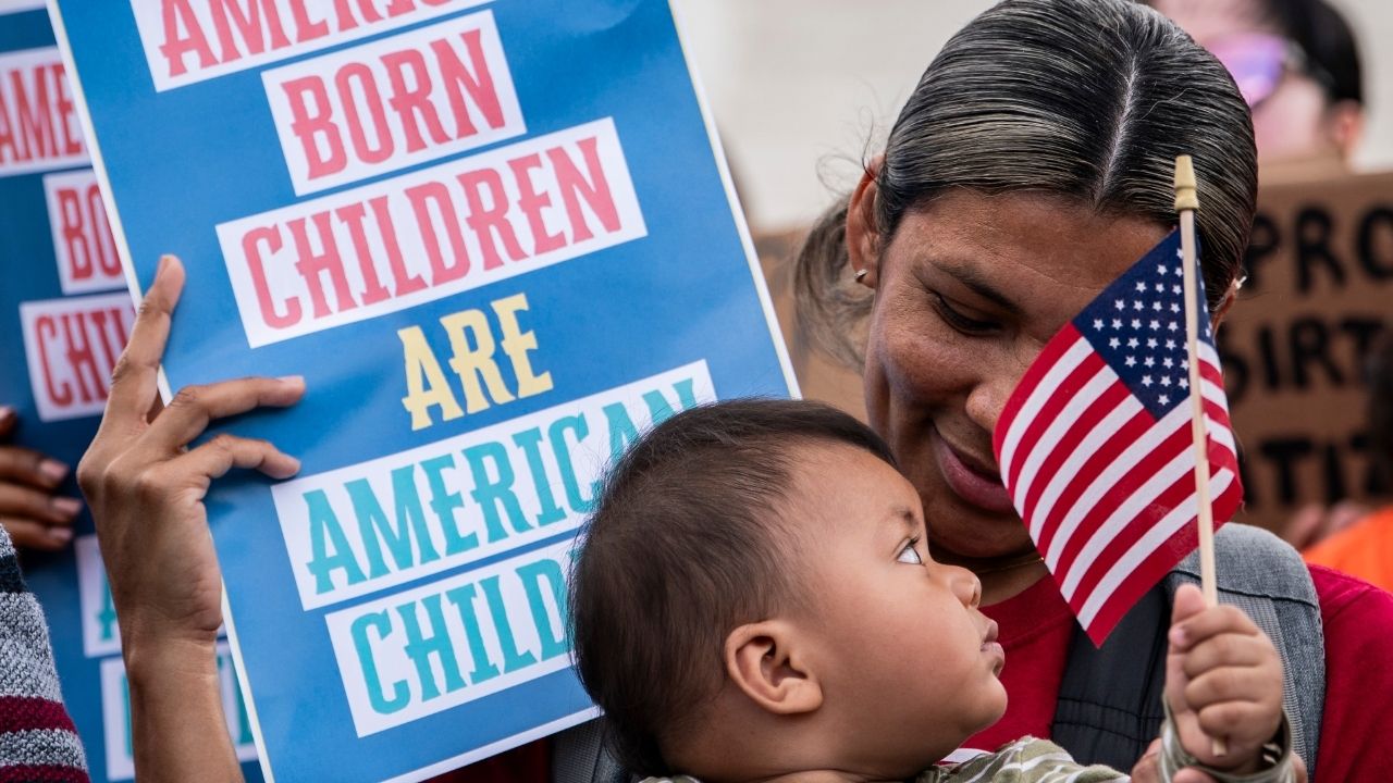 A mother with her child at a protest in favor of birthright citizenship outside the Supreme Court in Washington, May 15, 2025. The Supreme Court on Tuesday, June 30, 2026, struck down President Trump’s executive order limiting birthright citizenship, reaffirming the constitutional guarantees that nearly all children born on U.S. soil are citizens. (Haiyun Jiang/The New York Times)