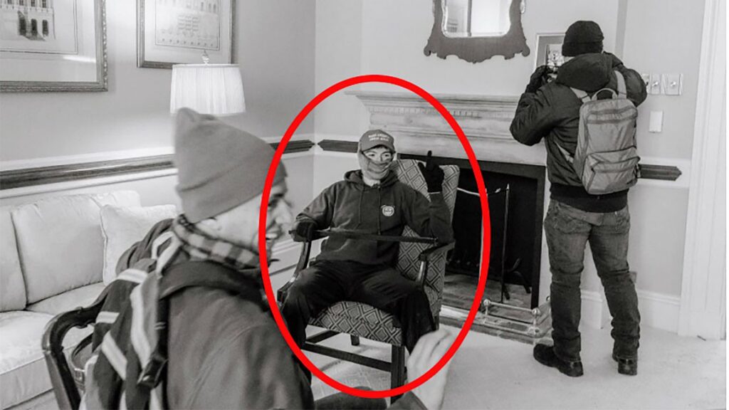 A photo provided by the Justice Department shows Elias Irizarry in a conference room at the U.S. Capitol in Washington, on Jan. 6, 2021, when he was videotaped by one of his friends sitting in an armchair with a pole across his lap. It was not clear who hired Irizarry to work in a sensitive Pentagon office; Irizarry pleaded guilty to various offenses at the Capitol and was later pardoned by President Donald Trump. (Justice Department via The New York Times)
