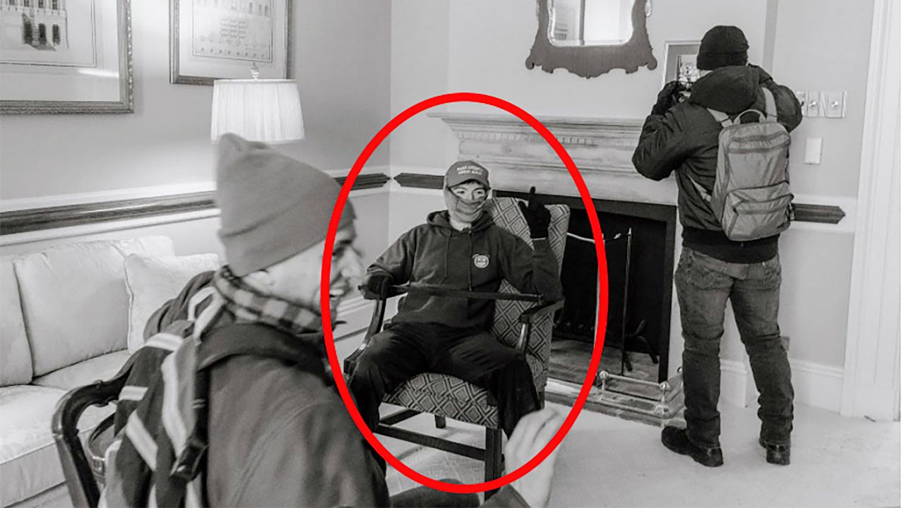A photo provided by the Justice Department shows Elias Irizarry in a conference room at the U.S. Capitol in Washington, on Jan. 6, 2021, when he was videotaped by one of his friends sitting in an armchair with a pole across his lap. It was not clear who hired Irizarry to work in a sensitive Pentagon office; Irizarry pleaded guilty to various offenses at the Capitol and was later pardoned by President Donald Trump. (Justice Department via The New York Times)