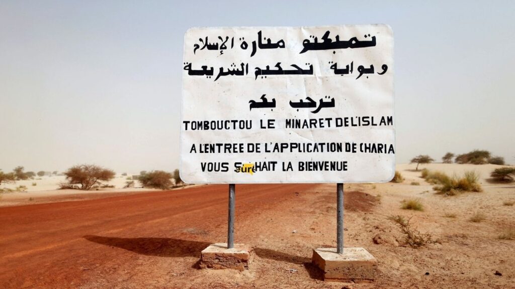A road sign written by Islamist rebels is seen at the entrance into Timbuktu January 31, 2013. The sign reads, "Timbuktu, the minaret of Islam and the entrance to the application of the Sharia law welcomes you." (Reuters File)