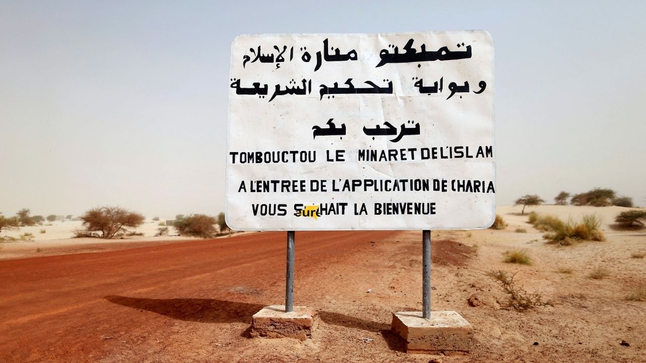 A road sign written by Islamist rebels is seen at the entrance into Timbuktu January 31, 2013. The sign reads, "Timbuktu, the minaret of Islam and the entrance to the application of the Sharia law welcomes you." (Reuters File)