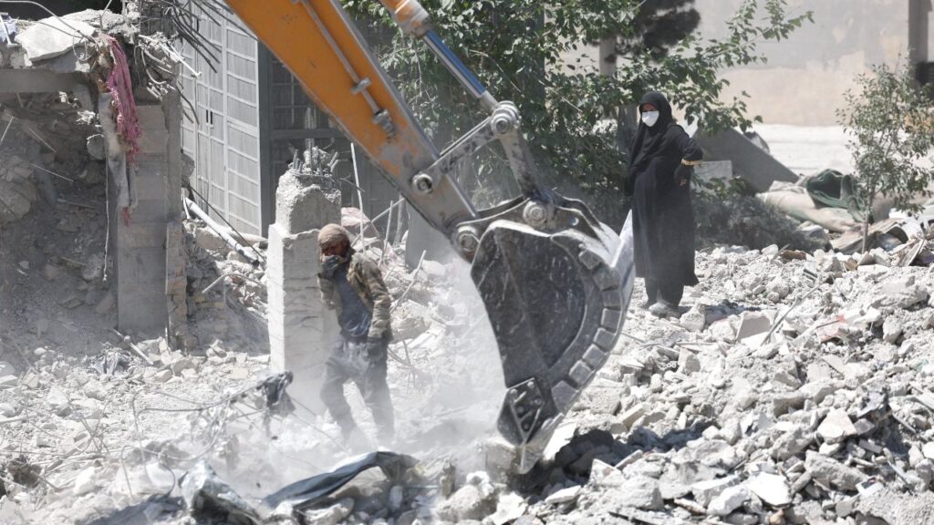 A woman stands among the rubble of her house, which was damaged in a U.S. and Israeli strike in March, in Tehran, Iran June 7, 2026. Majid Asgaripour/WANA (West Asia News Agency) via REUTERS