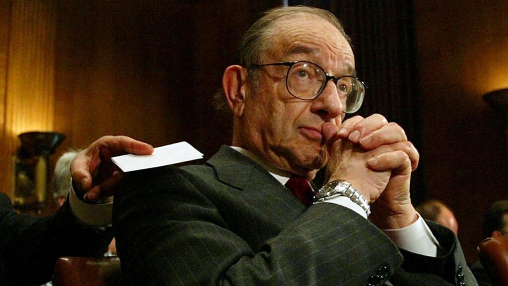 Alan Greenspan, chairman of the Federal Reserve Board of Governors, awaits the start of a Congressional hearing in Washington on April 20, 2004. Greenspan, who in nearly two decades as chair of the Federal Reserve nurtured a long run of prosperity, navigated crises and was a powerful and polarizing force in shaping market-friendly policies, died on Monday, June 22, 2026. He was 100. (Doug Mills/The New York Times)
